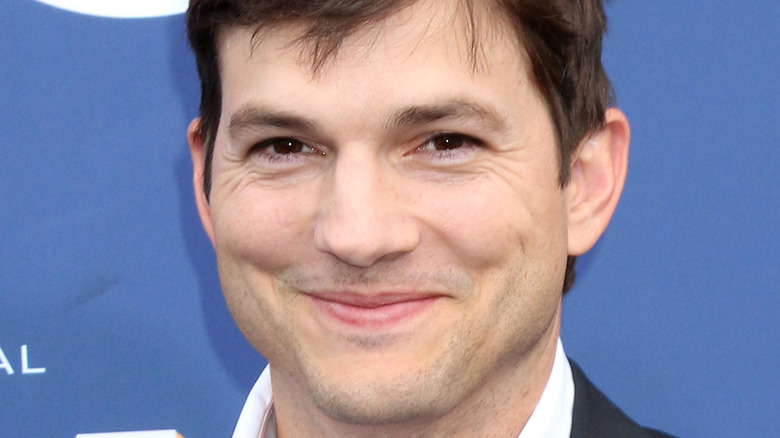 Ashton Kutcher smiles for cameras at event