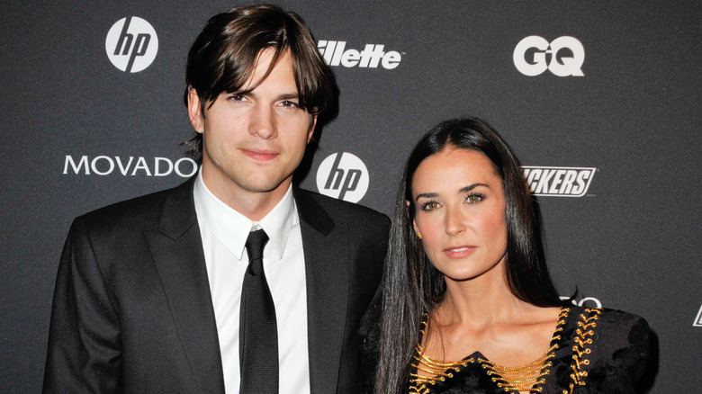 Ashton Kutcher and Demi Moore posing together in all black.