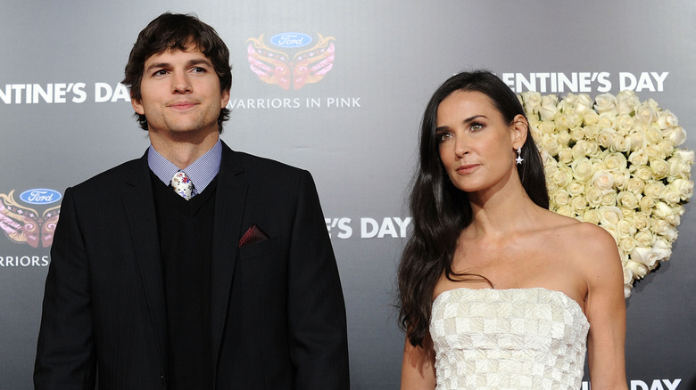 Ashton Kutcher and Demi Moore standing inches apart while posing for photo.