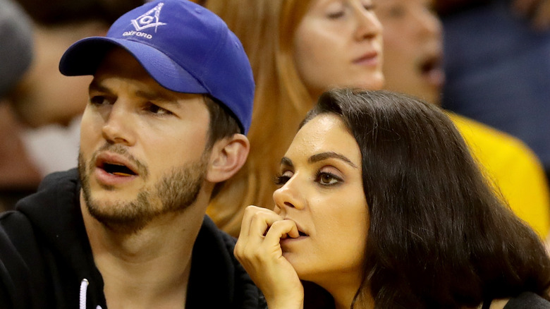 Ashton Kutcher and Mila Kunis watching an NBA game together.