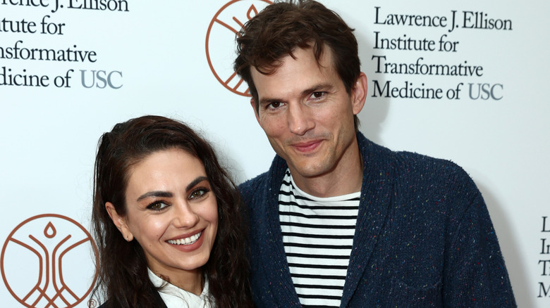 Ashton Kutcher and Mila Kunis smiling together in 2021.