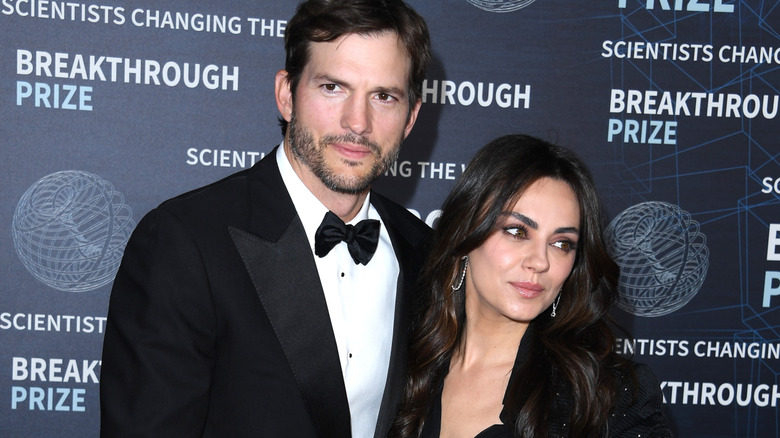 Ashton Kutcher and Mila Kunis pose for photos