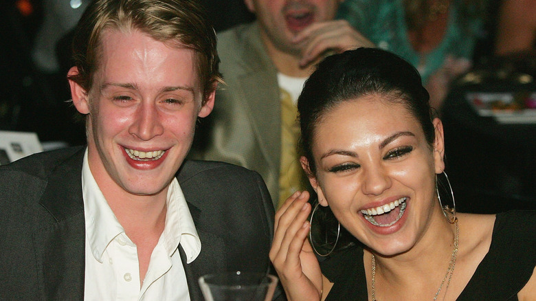Mila Kunis and Macaulay Culkin attend a 2005 charity event