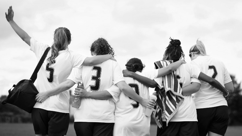 Female athletes huddled together