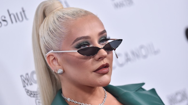 Christina Aguilera wearing a tight ponytail and tiny sunglasses