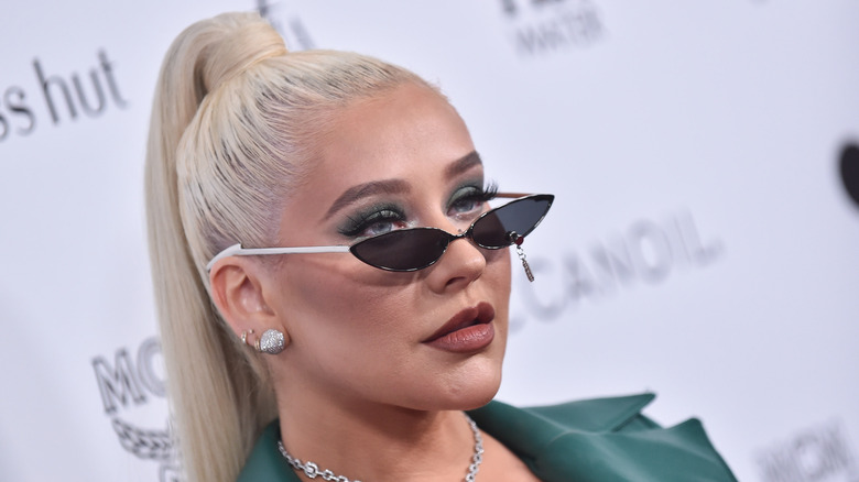 Christina Aguilera wearing a tight ponytail and tiny sunglasses