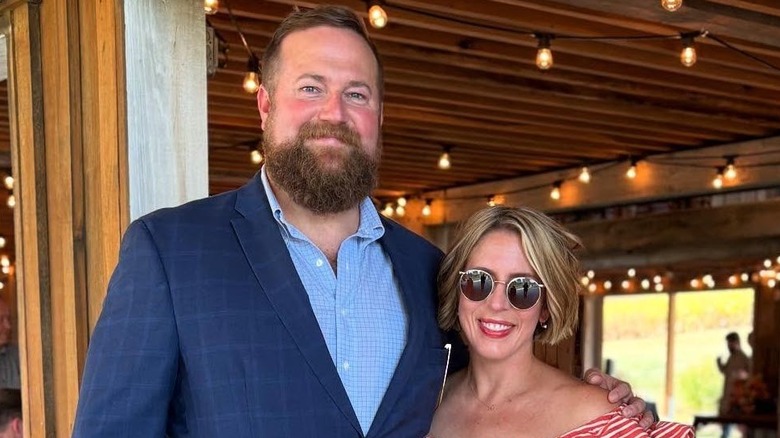 Ben and Erin Napier posing in nice clothing with arms around each other