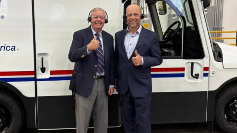 Lindsey Graham posing in front of a USPS truck.