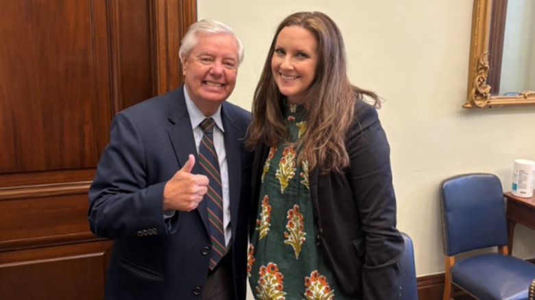 Lindsey Graham posing with a member of Moms for Liberty