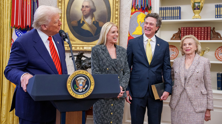 Donald Trump, Pam Bondi, John Wakefield and Patsy Bondi share a laugh at the Attorney General's swearing-in ceremony.
