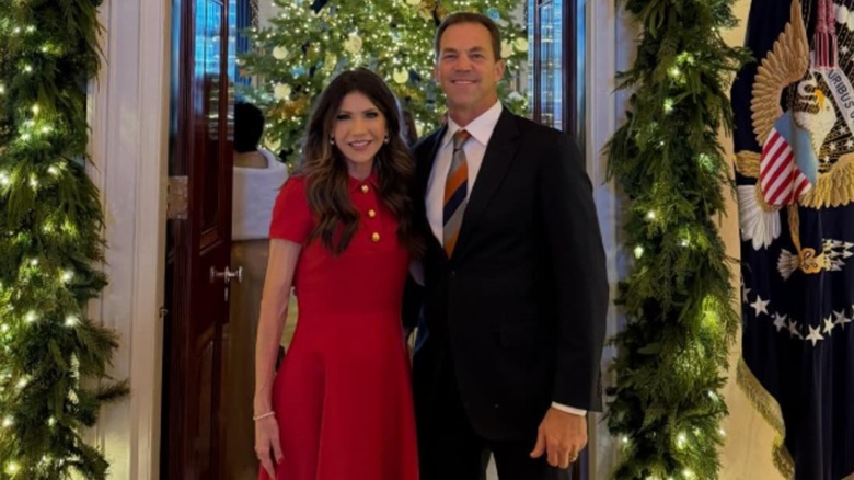 Kristi and Bryon Noem pose at The White House's Christmas party.