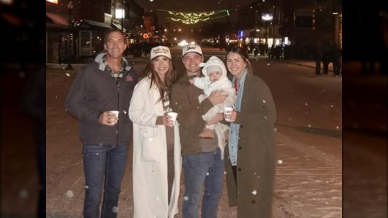 Kristi Noem posing in the snow with her husband, daughter, son-in-law and grandchild.