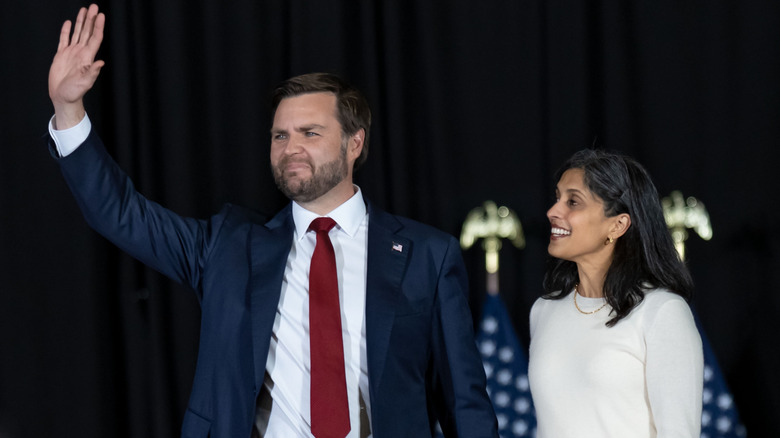 Usha looks up at JD during a rally.