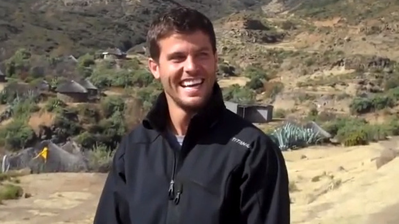 Eric Hill smiling and looking to the side in the mountains