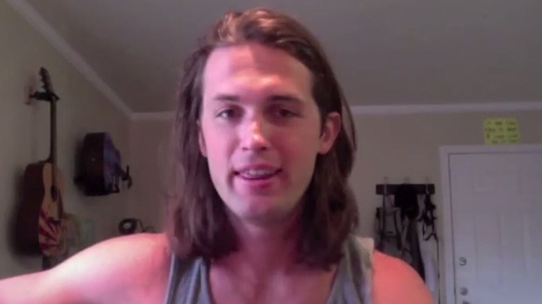 Michael Nance smiling and playing guitar