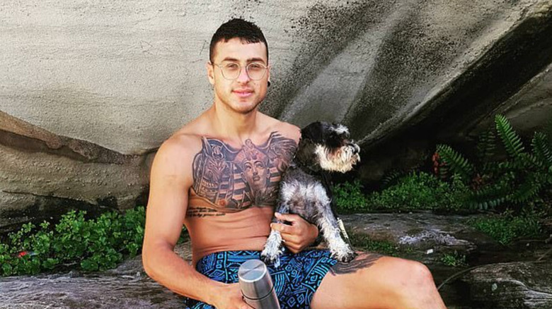 Samuel Minkin shirtless holding a dog