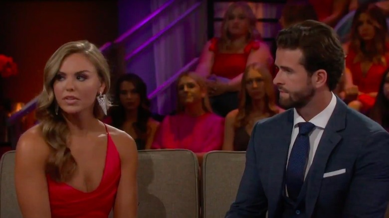 Hannah Brown seated next to Jed Wyatt as they both look upset while talking