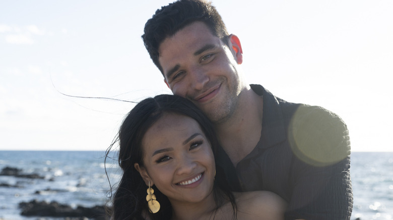 Jenn Tran and Devi Strader smiling and hugging together by the ocean