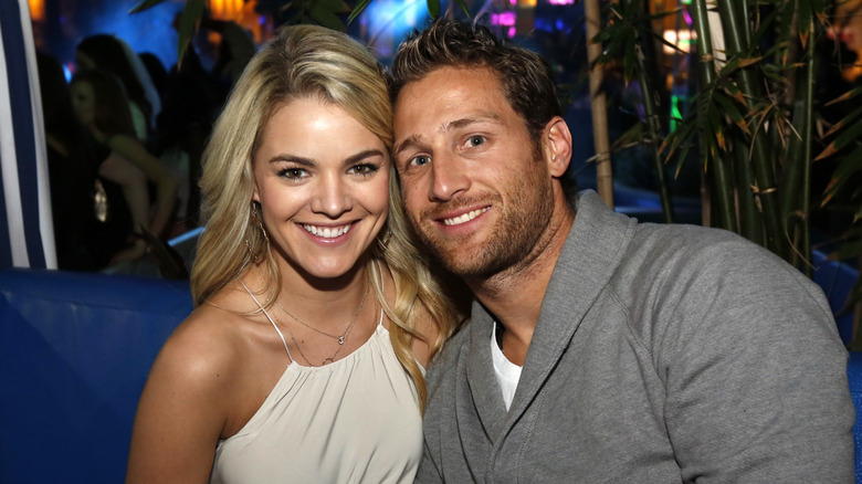 Nikki Ferrell sitting and smiling at party with Juan Pablo Galavis