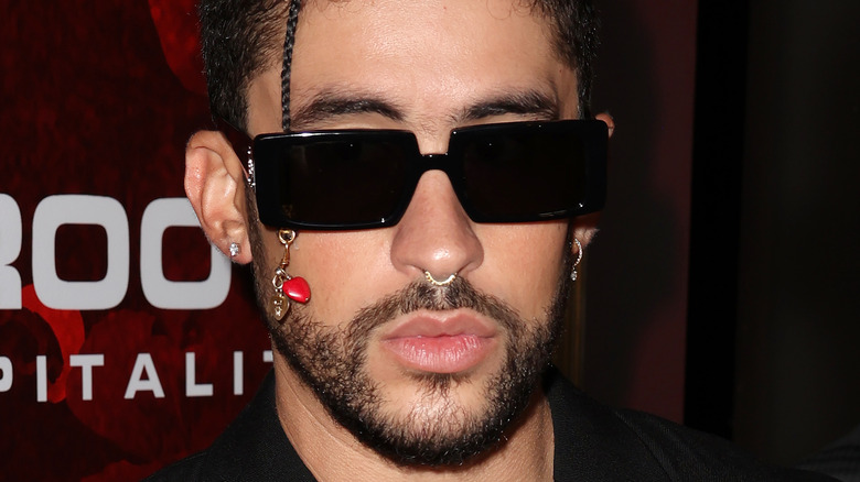 Bad Bunny posing for a photo with sunglasses on 