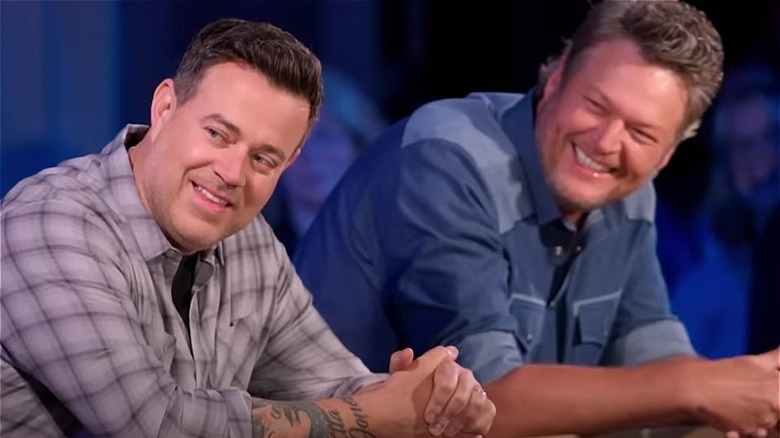 Carson Daly and Blake Shelton leaning forward