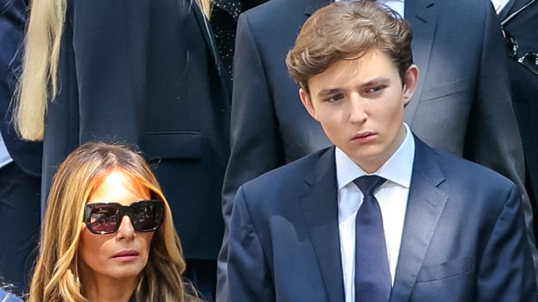 Melania and Barron Trump with somber expressions
