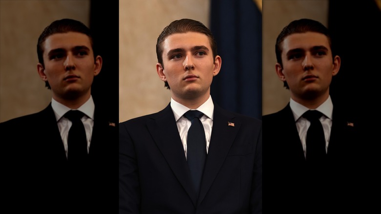 Barron Trump stands at attention