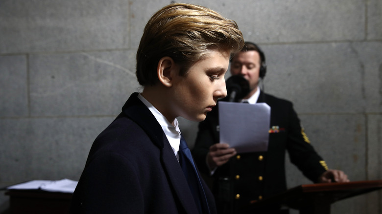 Barron Trump walks with his head down