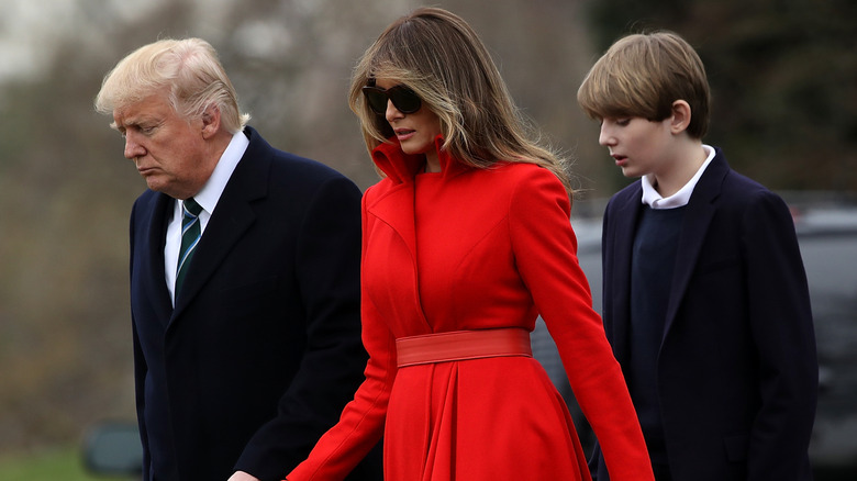 Barron Trump walking behind his parents