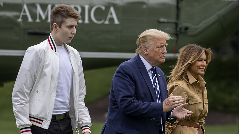 Barron Trump, Donald Trump and Melania Trump walk together