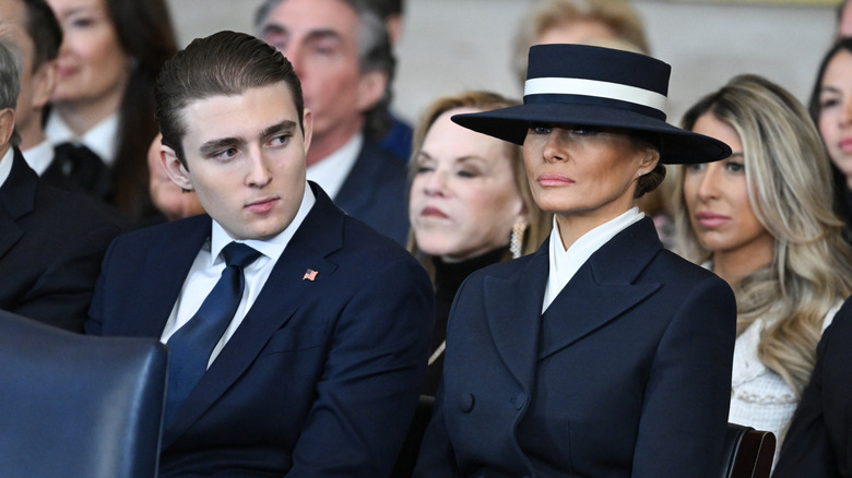 Barron Trump looks over at Melania Trump