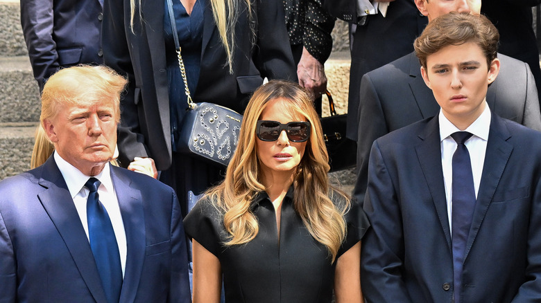 The Trumps with solemn expressions