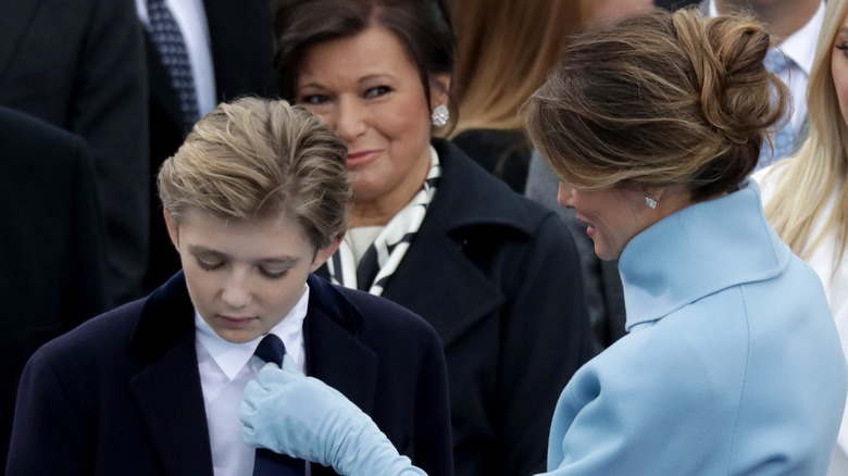 Melania Trump adjusting Barron Trump's tie