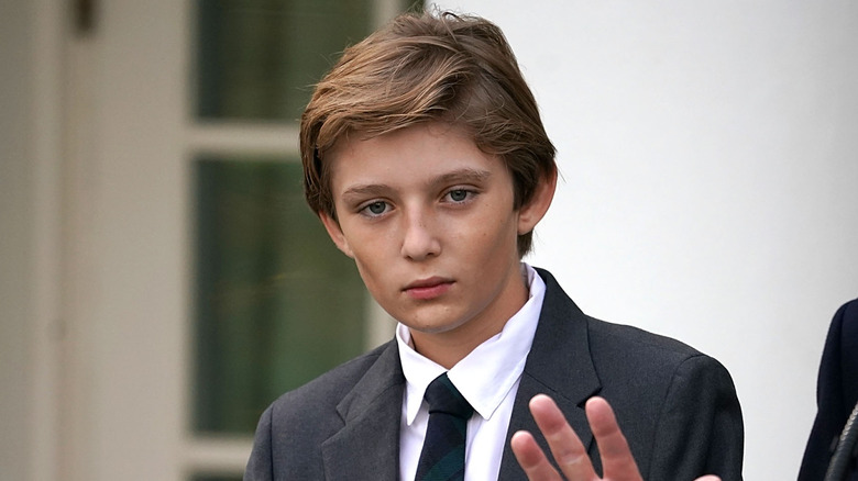 Barron Trump wearing a suit and looking ahead