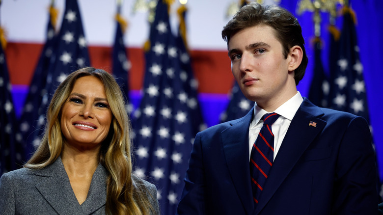 Melania and Barron Trump standing on stage and smiling