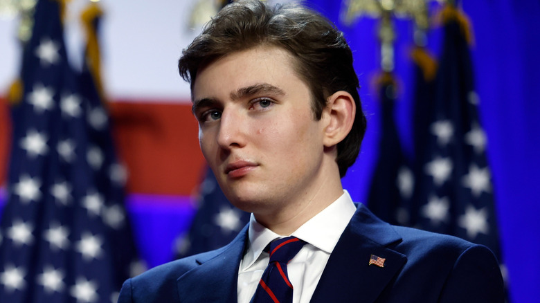 Barron Trump stands on stage after his father's 2024 victory.
