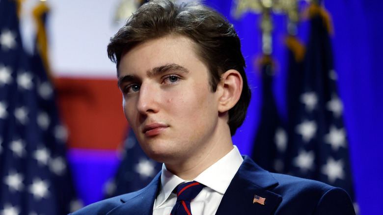 Barron Trump stands on stage after his father's 2024 victory.