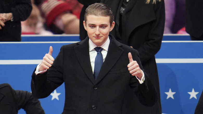 Barron Trump gives a double thumbs-up at his father's inauguration parade.