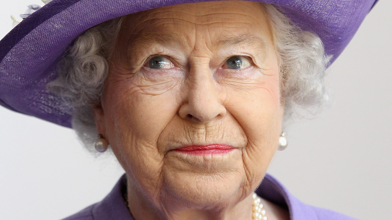 Queen Elizabeth small smile purple hat