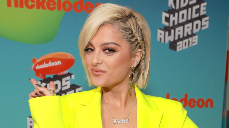 Bebe Rexha throwing up a peace sign