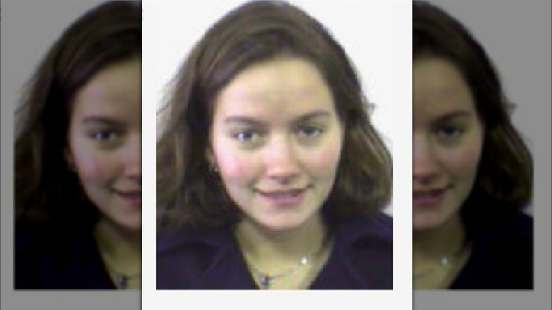 A young Becki Newton gazes at the camera, wearing a gentle smile.