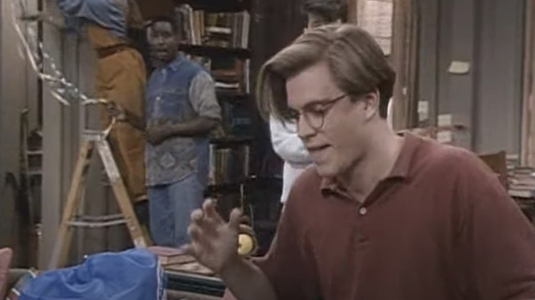 Weatherly in a red shirt, geek glasses