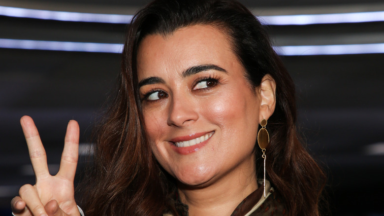Cote de Pablo doing peace sign