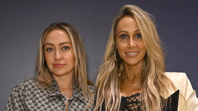 Brandi and Tish Cyrus pose together.