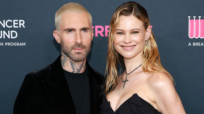 Behati Prinsloo and Adam Levine posing