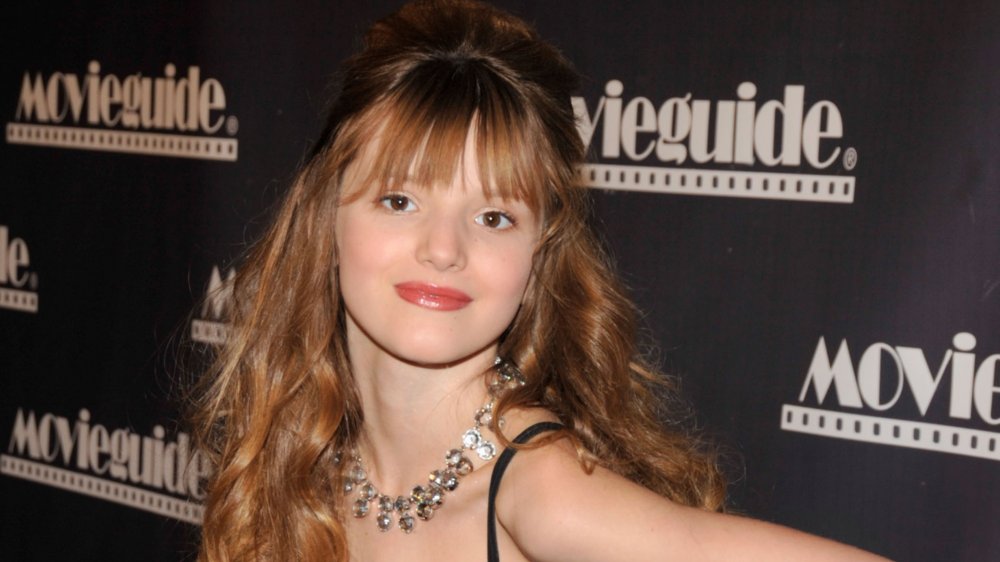 young Bella Thorne with bangs and a silver necklace