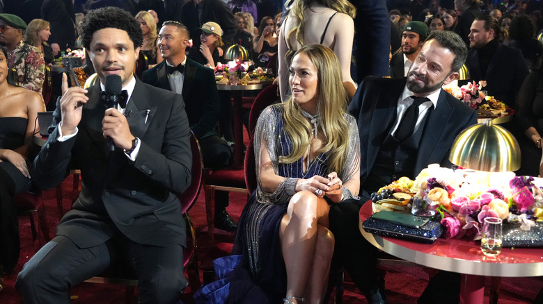 Ben Affleck and Jennifer Lopez sitting with Trevor Noah