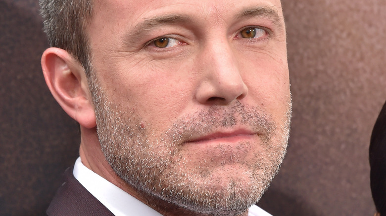 Ben Affleck poses in a brown suit