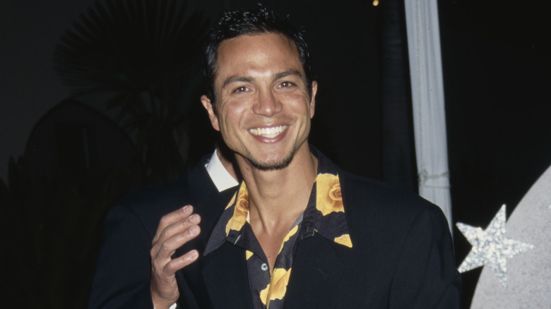 Benjamin Bratt laughing at a 1997 red carpet