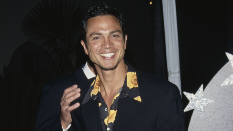 Benjamin Bratt laughing at a 1997 red carpet